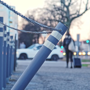 Chain attached to pole in front of building, cautioning against Public Property Accidents. - Lamb & Frischer Law Firm, LLP